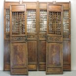 A set of six Chinese hardwood carved panels, decorated with flowers,