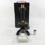A 20th century microscope, in a wooden case,