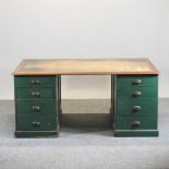 An early 20th century green painted pine and light oak partner's pedestal desk,