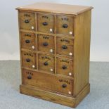 An oak haberdashery chest, with ten labelled drawers,