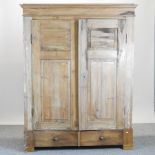 An antique pine double wardrobe,