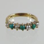 A 9 carat gold turquoise and pearl seven stone ring