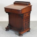 A Victorian walnut davenport,