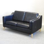 A modern Danish style black upholstered sofa, on square legs,