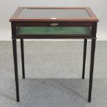 A reproduction mahogany bijouterie table, on square legs,
