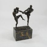 A bronze figure group of kickboxers,