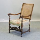 An early 20th century open armchair, with a cane back,