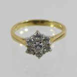 An 18 carat gold daisy set seven stone diamond cluster ring