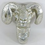 A silver painted model of a ram's head,