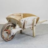 A vintage hand made wooden wheelbarrow,