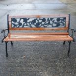 A wooden slatted garden bench, with cast iron ends,