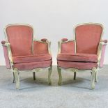 A pair of early 20th century French style pink upholstered bergere chairs