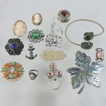 A collection of costume jewellery to include brooches and a bangle