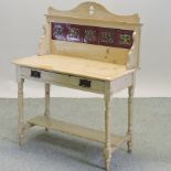 An Edwardian pine washstand, with a tile back,