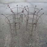 A collection of four iron garden plant frames,