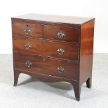 A Regency style mahogany chest of drawers, on swept bracket feet,