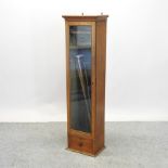 An Edwardian light oak gun cabinet, 152cm high,