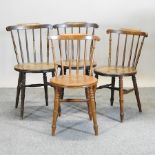 A collection of four early 20th century spindle back dining chairs,