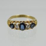 An 18 carat gold sapphire and diamond boat shaped five stone ring,