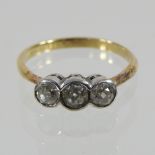 An 18 carat gold rub over set three stone diamond ring, approximately 0.