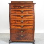 A 19th century continental flame mahogany chest, containing seven short drawers,