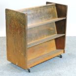 A mid 20th century library trolley, on castors,