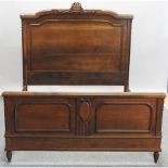 A 19th century French oak double bed, with a slatted wooden base,