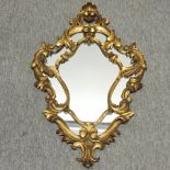 A Rococo style gilt framed wall mirror,