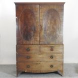 A George III mahogany linen press, on swept bracket feet,