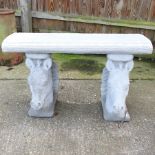 A reconstituted garden bench, the supports in the form of horse heads,