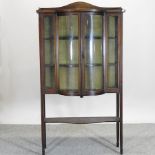 A Victorian mahogany and inlaid bow front display cabinet,