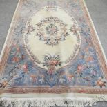 A modern Chinese rug, with floral designs on a cream ground,