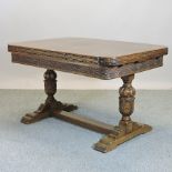 An early 20th century oak draw leaf dining table,