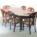 A Victorian walnut wind out extending dining table, with two additional leaves and winder,