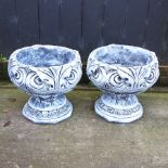 A pair of reconstituted stone garden urns,