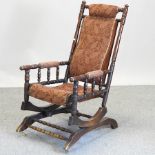 A 19th century American red upholstered rocking chair