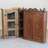A pine hanging cabinet, together with a pine bookcase,