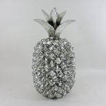 A large silver painted model of a pineapple,
