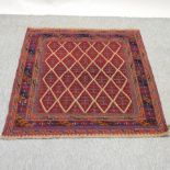 A tribal woollen rug, with all over diamond design,