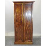 A 19th century mahogany hall cupboard, with panelled doors,