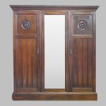 An Edwardian walnut triple wardrobe,