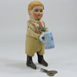 A 1930's Shuco tin plate clockwork figure of boy drinking form a stein,