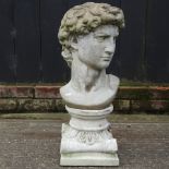 A reconstituted stone bust of a man, on a similar plinth,