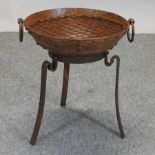 A metal fire pit, on stand,