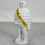 A large painted cast iron model of the Michelin man,