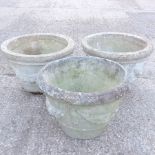 A set of three reconstituted stone garden planters,