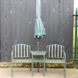 A green painted metal lover's seat, together with a parasol,