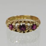 An 18 carat gold ruby and diamond five stone ring