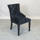 A black upholstered button back bedroom chair