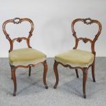 A set of four Victorian carved walnut dining chairs, with green upholstered seats,